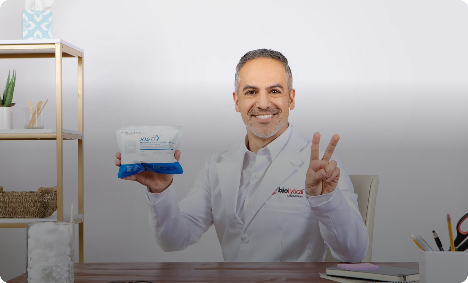 bioLytical Laboratories healthcare professional holding INSTI Multiplex HIV and Syphilis rapid test kit