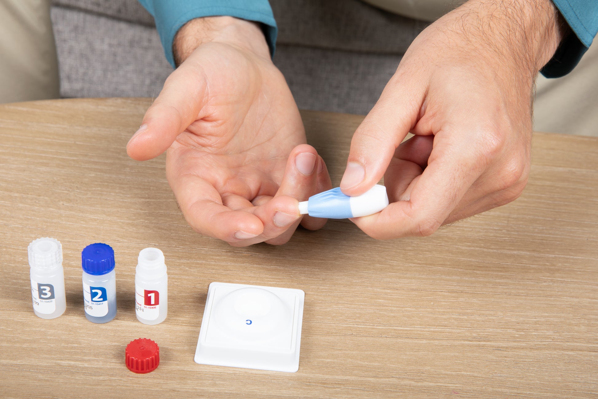 Step-by-step INSTI HIV self-test fingerstick blood collection using lancet and numbered bottles