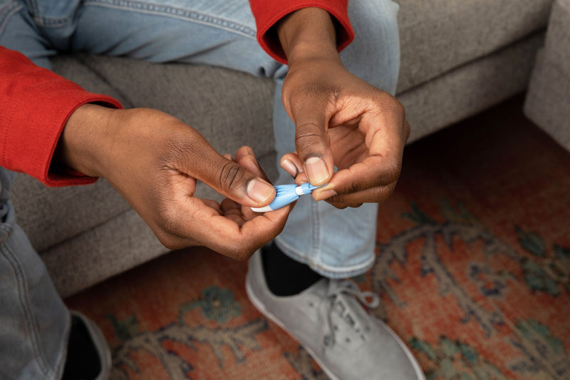 Removing lancet cap as first step of INSTI HIV self-test fingerstick blood collection
